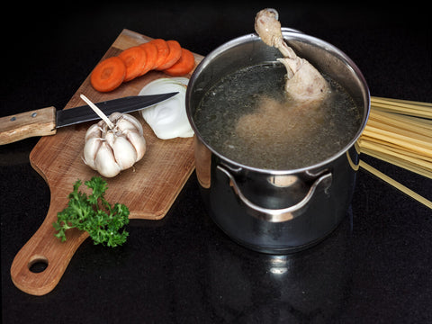 chicken soup ingredients and a pan fresh chicken broth