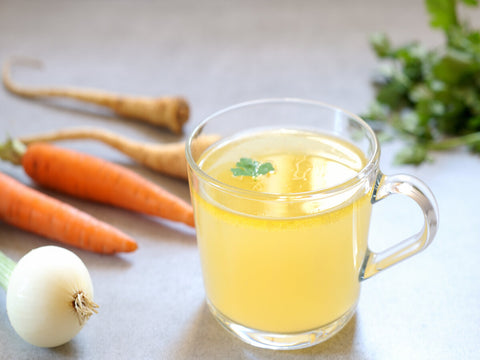 clear homemade bone broth in a glass